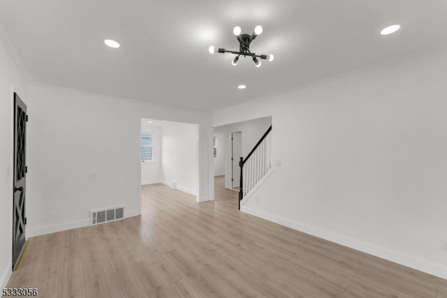 unfurnished room with light wood-type flooring and ornamental molding