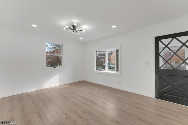 foyer entrance featuring an inviting chandelier and light hardwood / wood-style floors