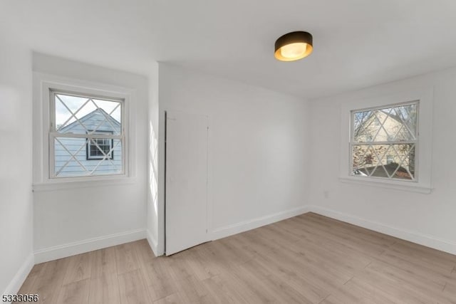 unfurnished room with light wood-type flooring