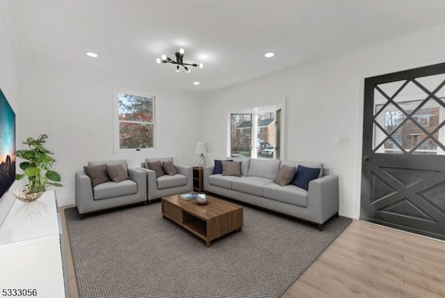 living room featuring an inviting chandelier and hardwood / wood-style floors