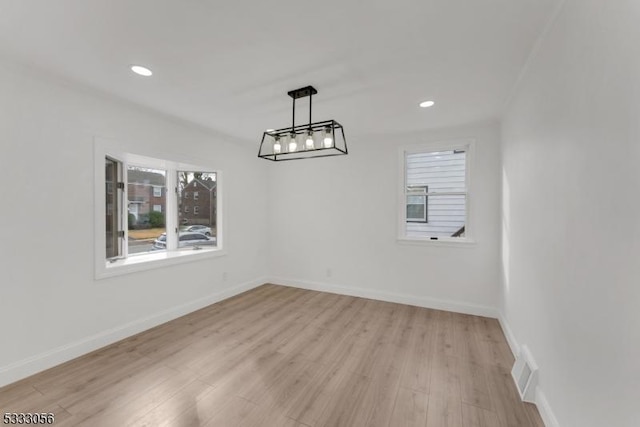 unfurnished dining area featuring light wood-type flooring