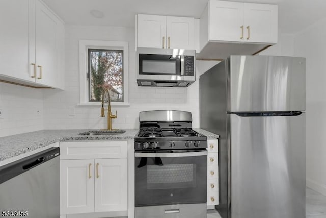 kitchen featuring stainless steel appliances, white cabinets, and sink