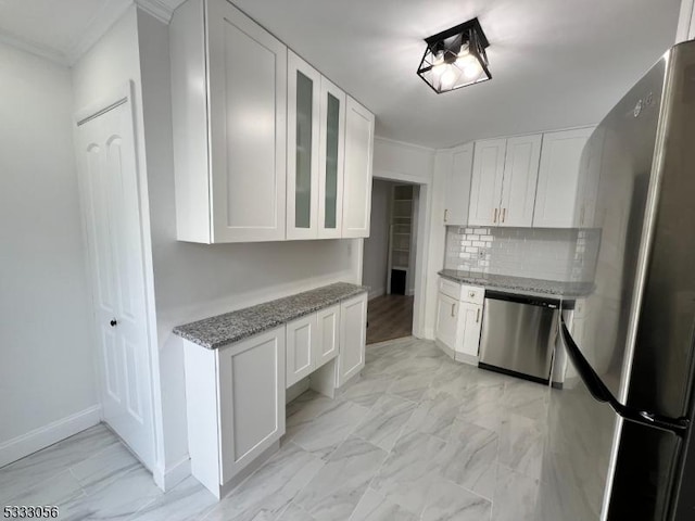 kitchen with stainless steel appliances, light stone countertops, tasteful backsplash, and white cabinetry