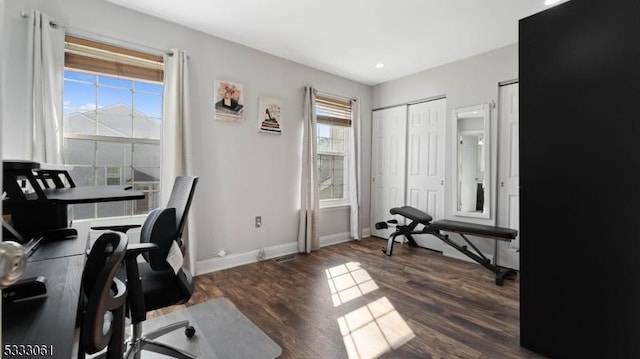 office space with a healthy amount of sunlight and dark wood-type flooring