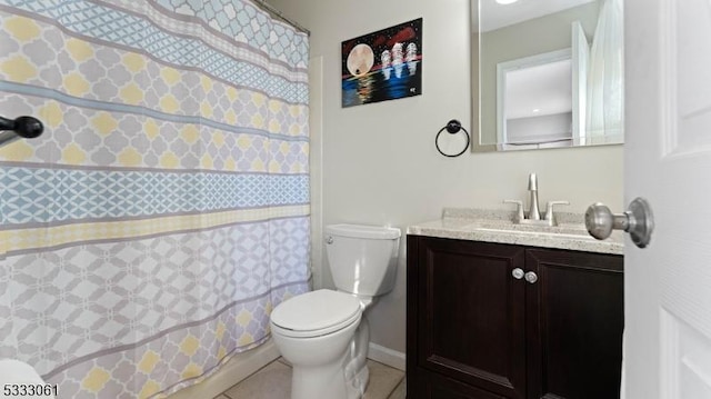 bathroom featuring tile patterned flooring, vanity, and toilet