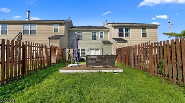 rear view of house with a lawn and a patio