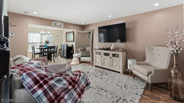 living room featuring hardwood / wood-style flooring and a chandelier