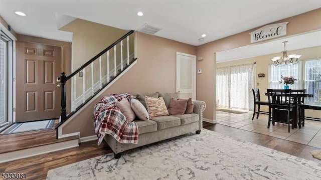 living room with a notable chandelier and hardwood / wood-style floors