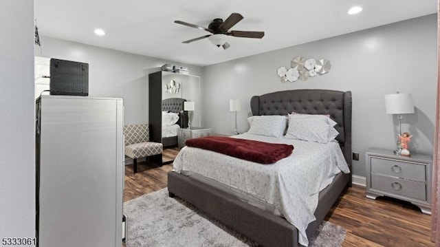 bedroom with ceiling fan and dark wood-type flooring