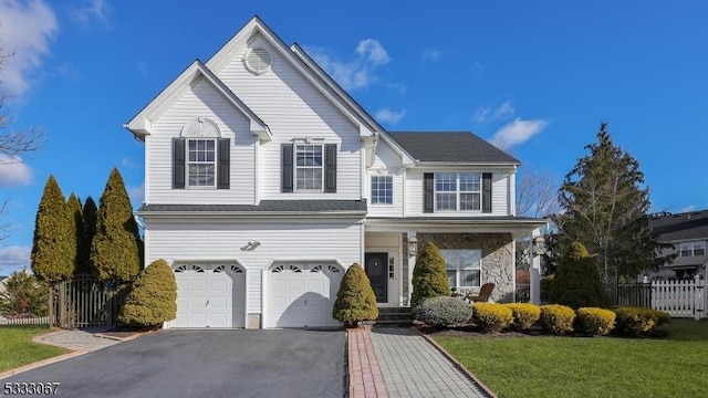 view of property featuring a front lawn and a garage