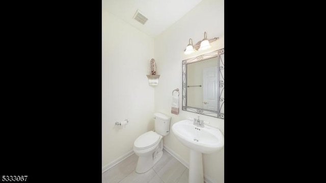 bathroom featuring toilet and tile patterned floors