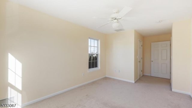 unfurnished room with light carpet and ceiling fan