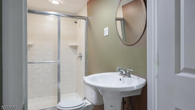 bathroom with toilet and walk in shower