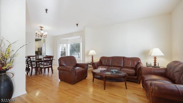 living room featuring a chandelier and wood-type flooring