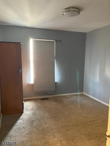 unfurnished room featuring baseboards
