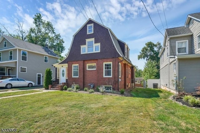 view of front of property with a front lawn and central AC unit