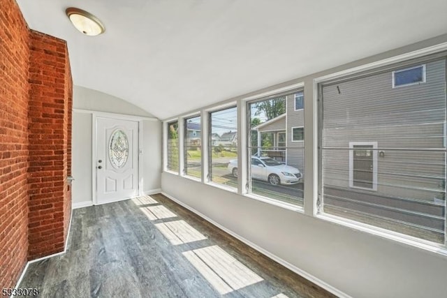 unfurnished sunroom featuring lofted ceiling