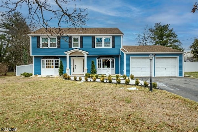 view of front of house with a garage and a front yard