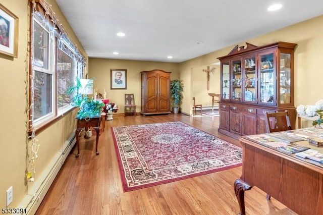 interior space with light wood-type flooring and baseboard heating