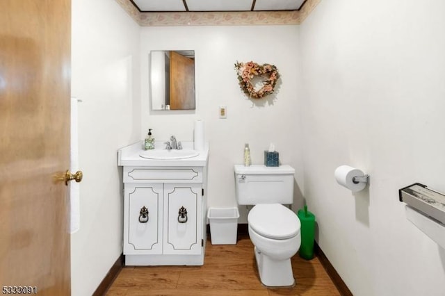 bathroom featuring hardwood / wood-style floors, toilet, and vanity