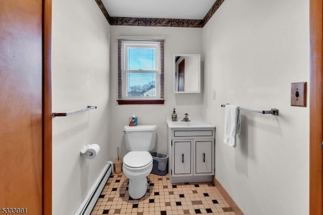 bathroom with baseboard heating, toilet, and vanity