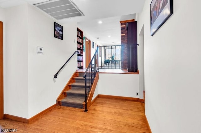 stairs with hardwood / wood-style floors