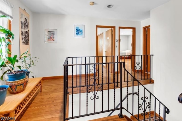 hallway with hardwood / wood-style floors