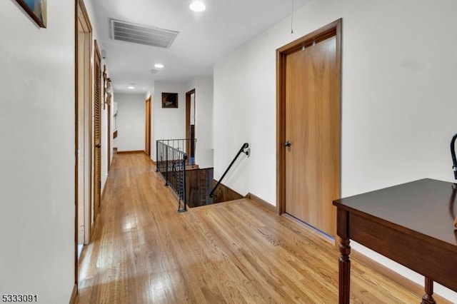 hallway with light hardwood / wood-style floors