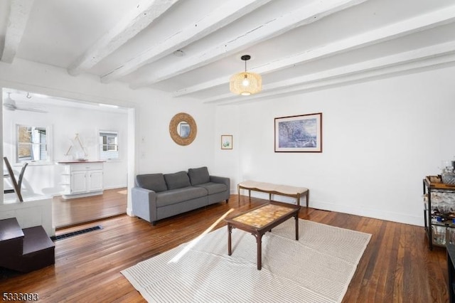 living room with dark hardwood / wood-style floors and beamed ceiling