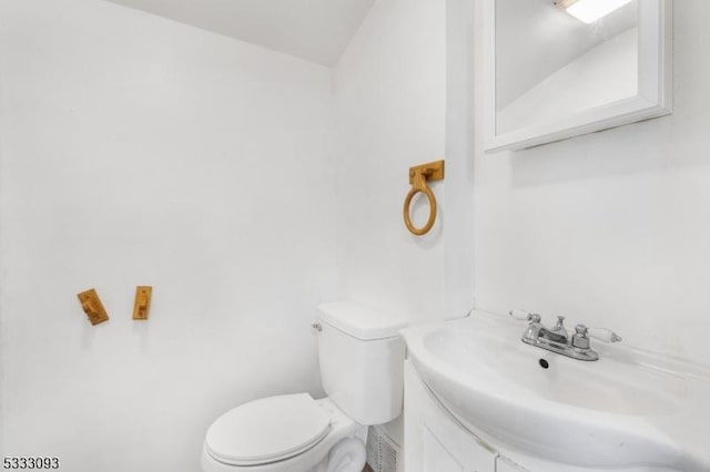 bathroom featuring toilet and vanity