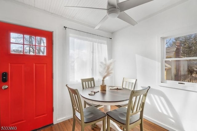 dining space featuring ceiling fan, dark hardwood / wood-style flooring, and a healthy amount of sunlight