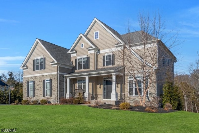 craftsman inspired home with covered porch and a front lawn