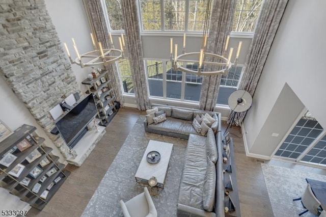 living room with a notable chandelier, a wealth of natural light, and hardwood / wood-style floors