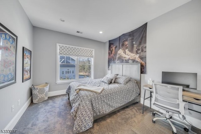 bedroom with dark colored carpet