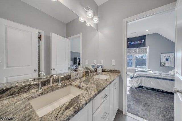 bathroom with vaulted ceiling and vanity