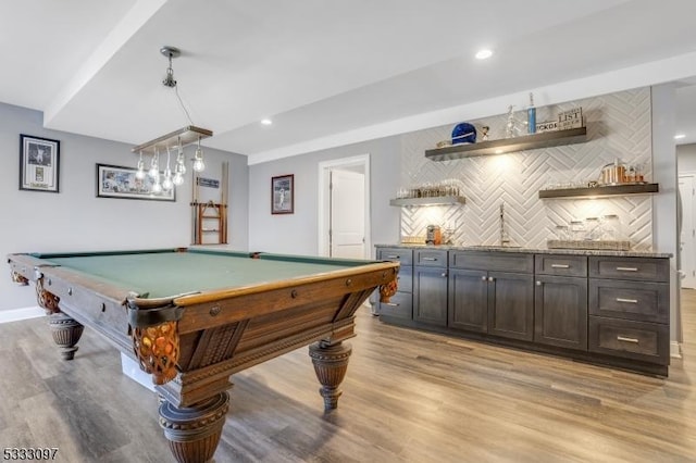 playroom featuring billiards, bar, and light wood-type flooring