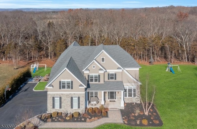 view of front of home with covered porch and a front yard