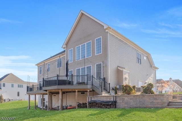 rear view of house with a deck and a yard