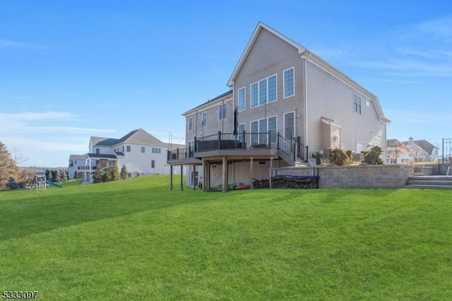 back of property featuring a lawn and a deck