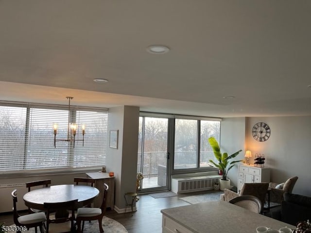 living room with radiator, a chandelier, and hardwood / wood-style flooring