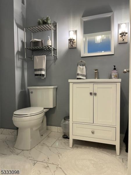 bathroom with toilet and vanity