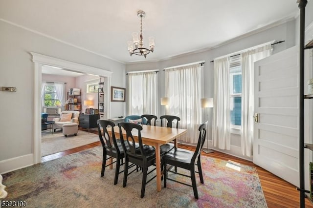 dining area featuring light hardwood / wood-style flooring and a notable chandelier