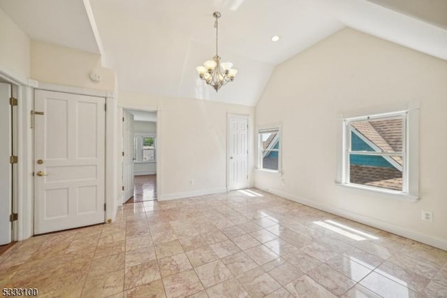 entryway with lofted ceiling and a chandelier