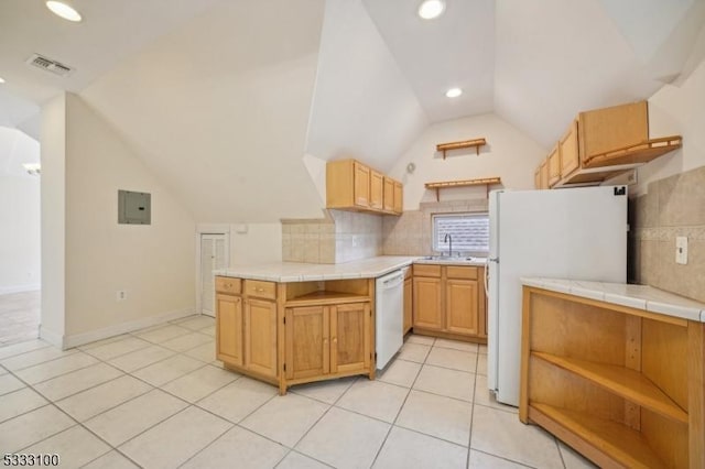 kitchen with tasteful backsplash, white appliances, tile counters, and vaulted ceiling