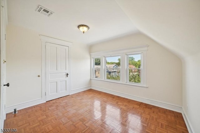 bonus room featuring vaulted ceiling and light parquet floors