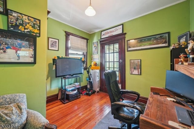 office with hardwood / wood-style flooring and ornamental molding