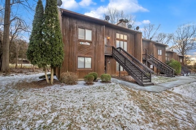 view of snow covered back of property