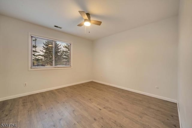 unfurnished room with ceiling fan and wood-type flooring