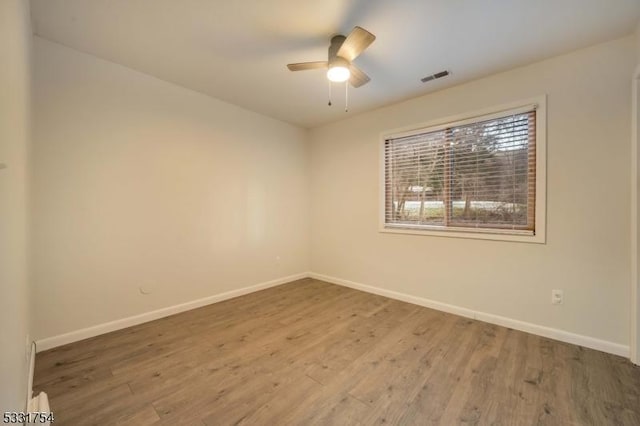 spare room with ceiling fan and hardwood / wood-style floors