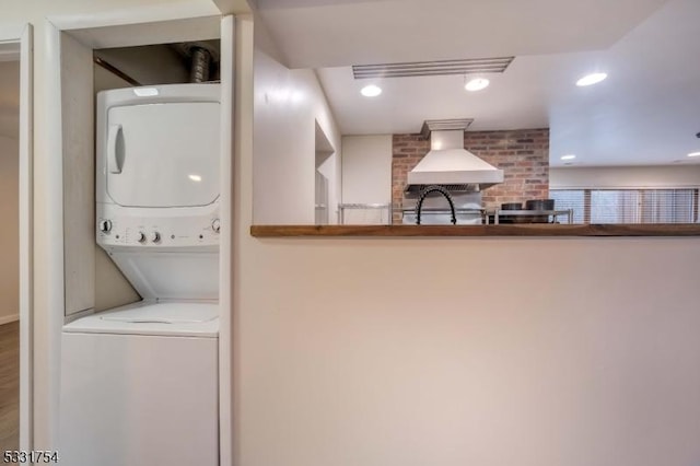 laundry area with stacked washer / dryer